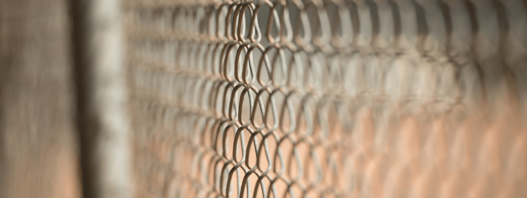 A close up picture of a chain link fence to symbolize barriers.