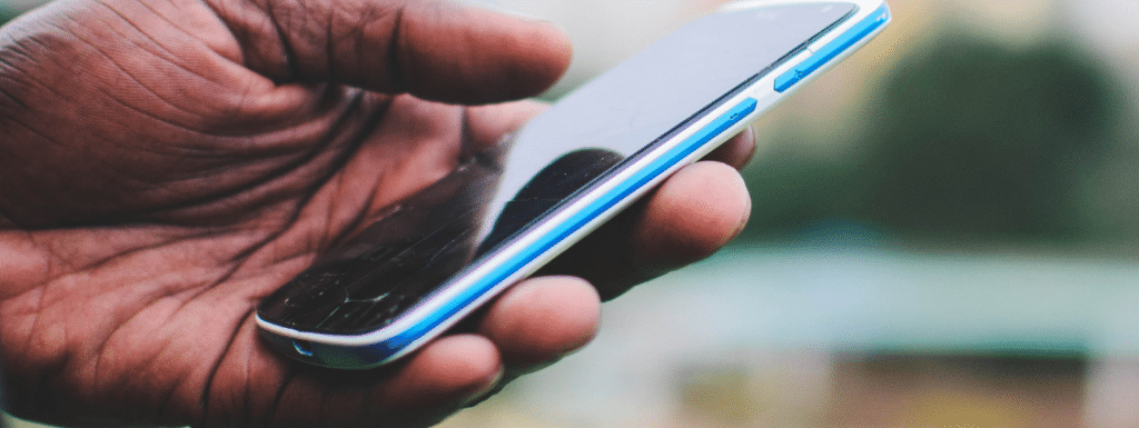 Hand holding a mobile phone.