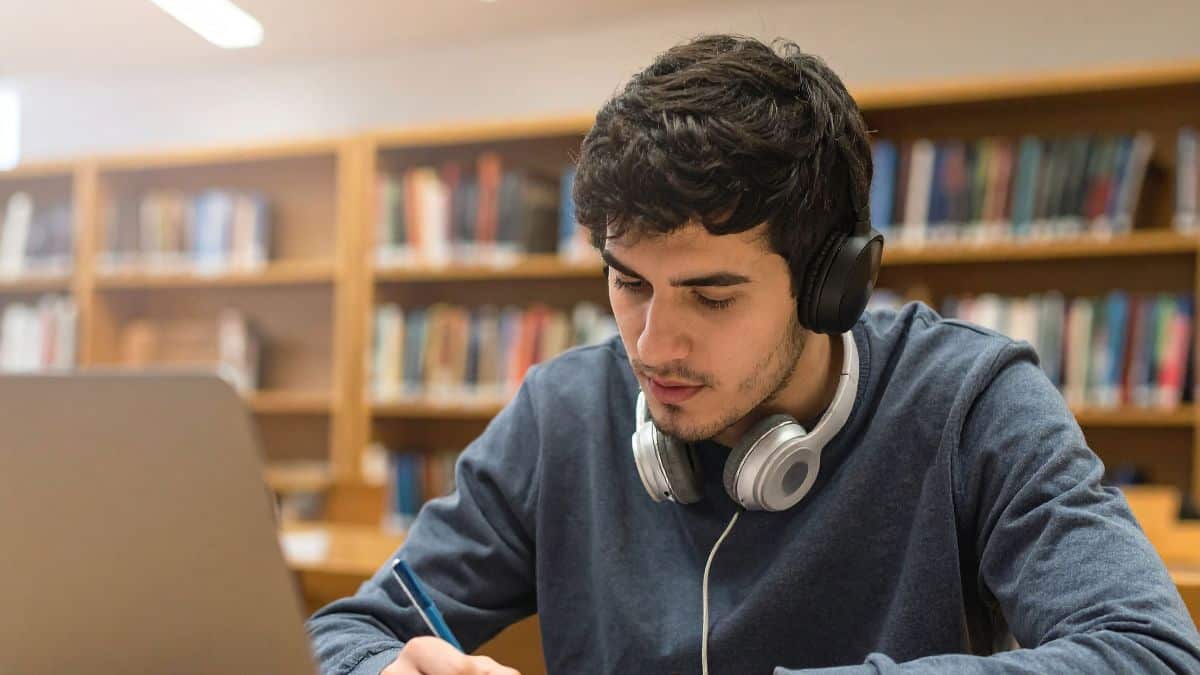 A person at a dest with headphones on