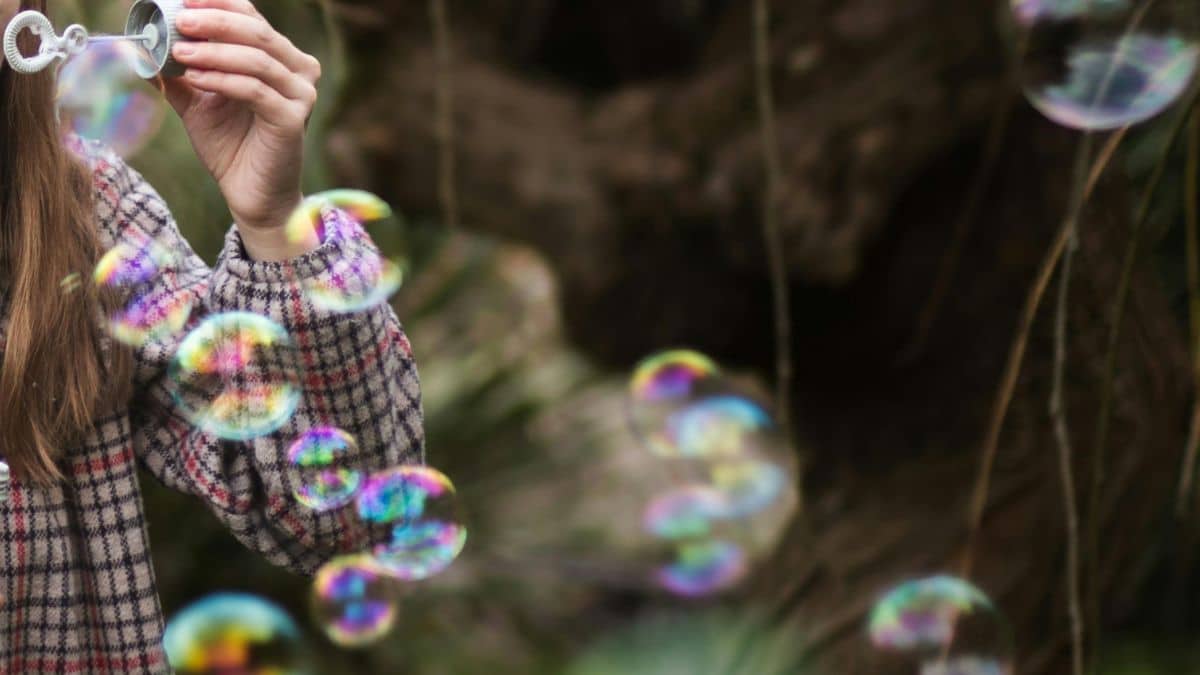 Feature image a person blowing soap bubbles