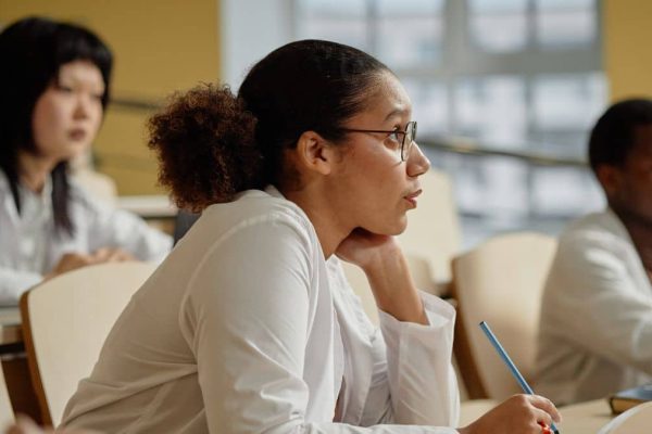 Three people in a lecture hall