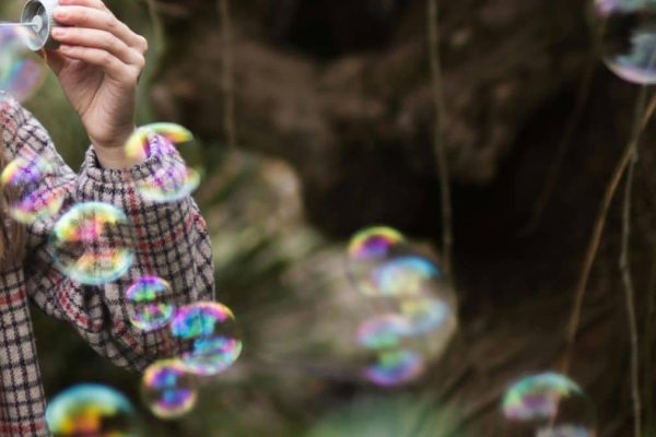 Feature image a person blowing soap bubbles
